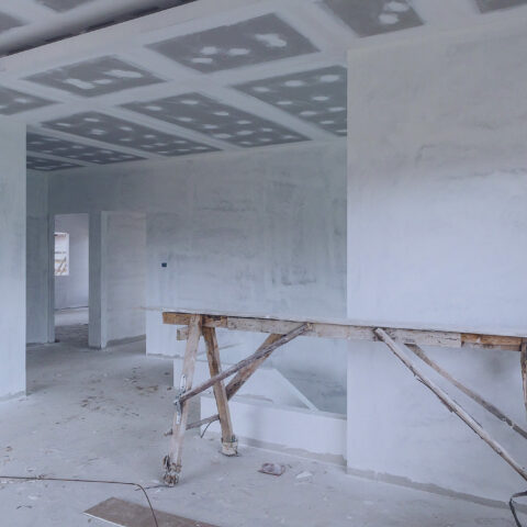 Empty room interior with gypsum board ceiling at house construction site